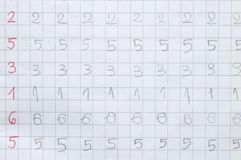 Rows of numbers written by a child in a grid notebook. Teaching writing and n Stock Photos