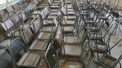 Rows of old chairs stacked on top of each other Stock Footage 81804562