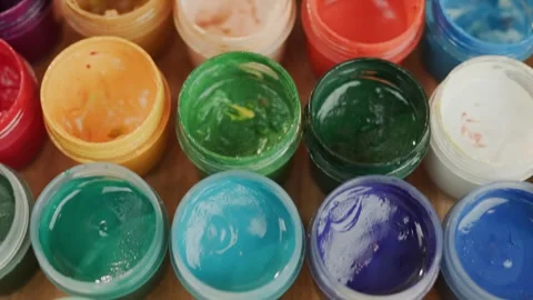 Rows of open paint pots in various bright colors slowly move into focus, re.. Stock Footage 334995613