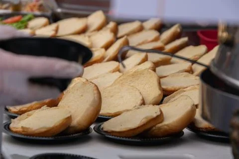 Rows of opened empty hamburger buns on a table without any meat filling Stock Photos