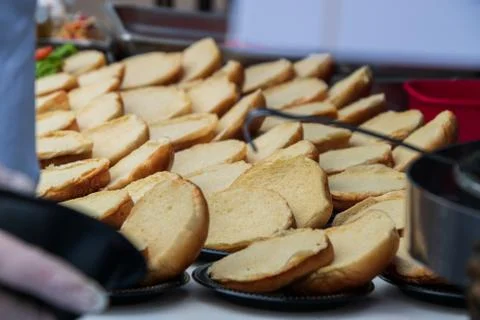 Rows of opened empty hamburger buns on a table without any meat filling Stock Photos
