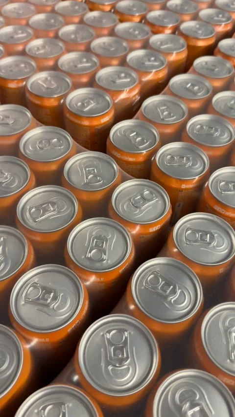 Rows of orange soda cans create a metallic pattern and industrial background Stock Footage 331462030
