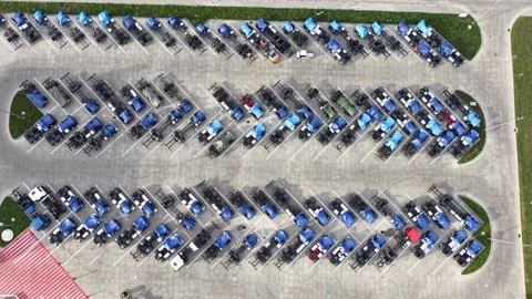 Rows of parked trucks and lorries in a large paved vehicle storage lot Видео 347413684
