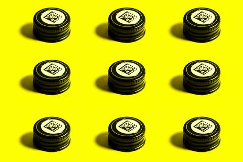 Rows of pattern lids from a bottles of alcohol with a barcode. Stock Photos