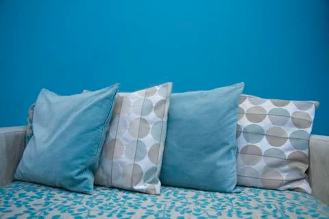 Rows of pillows with blue sky wall background Stock Photos