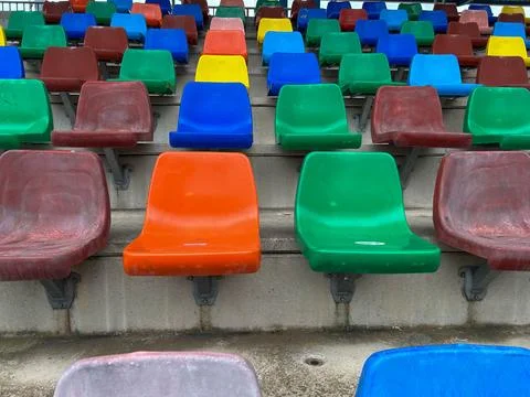 Rows of plastic seats of different colors Stock Photos