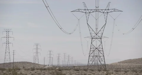 Rows of Power lines and Towers in California Desert along Highway Stock Footage 89942610