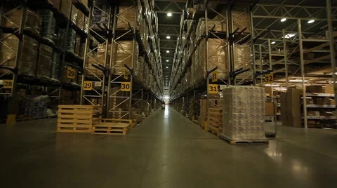 Rows of racks and loader in a huge warehouse Stock Footage 64045038
