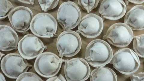 Rows of raw dumplings rotate in 4K Stock Footage 140756974