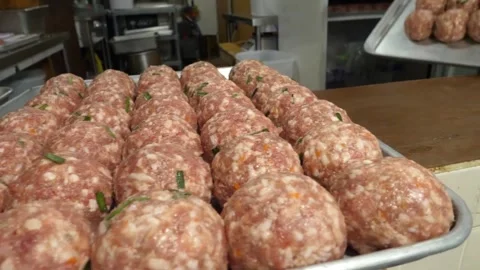Rows of Raw Meatballs on Metal Trays in Commercial Kitchen Video stock 343588360