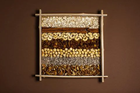 Rows of raw organic nuts and oatmeal for granola in box Stock Photos
