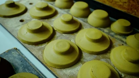 Rows of raw, unfired clay lids for traditional pots drying on a wooden board. Stock Footage 328925663