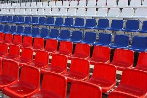 Rows of red, blue and white plastic chairs Stock-Fotos