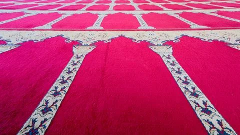 Rows of red mosque prayer carpets in perspective Stock Photos