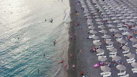 Rows of reed umbrellas at the sandy beach in Canj Montenegro Stock Footage 136127340