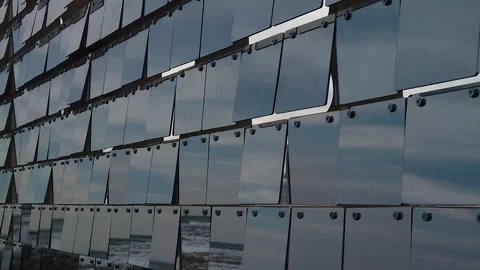 Rows of reflective plexiglass panels moving in tandem with the wind, slow Video stock 303497600