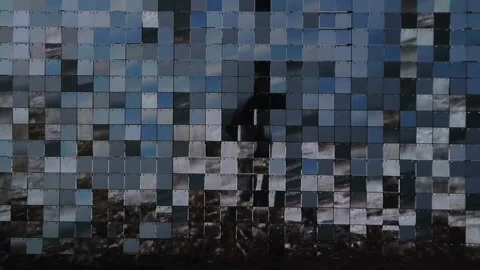 Rows of reflective plexiglass panels moving in tandem with the wind, slow Video stock 303786846