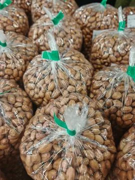 Rows of Roasted Peanuts in Transparent Bulk Retail Packaging copy2 Stock Photos