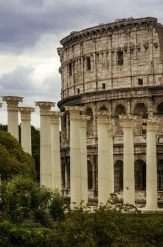 Rows of Roman pillars or columns and the Colosseum amphitheater. Stock Photos