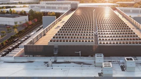 Rows of rooftop cooling fans run the length of a hyperscale data center in Stock Footage 345728532