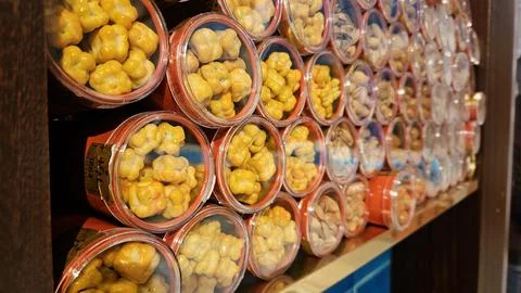 Rows of Round Containers Filled with Yellow Turkish Chickpea Candy on Shelf Stock Photos
