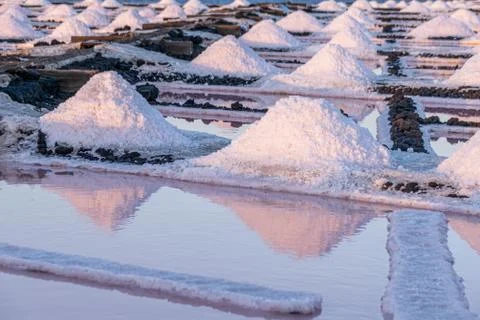 Rows of salt piles and different colours of water basins Stock Photos