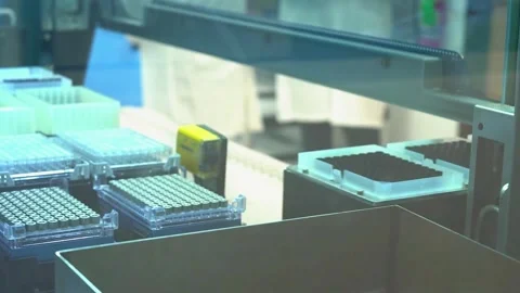 Rows of sample tubes under blue light in a crime laboratory testing DNA samples Vídeo Stock 345363718