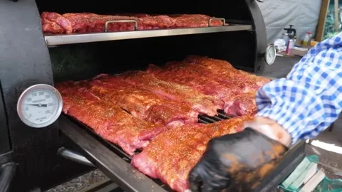 Rows of Seasoned Ribs Cooking in an Offset Barbecue Smoker Video stock 338212313