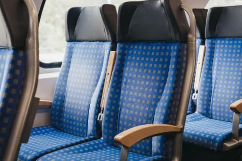 Rows of seats inside empty modern train, travel concept, selective focus. Stock Photos