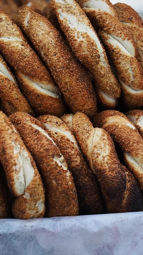 Rows of sesame bread loaves displayed at a bakery for sale Stock Footage 348259194