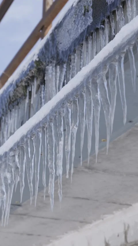 Rows Of Sharp Icicles Hanging From Metal Railing During Freezing Winter Day Stock Footage 330270876