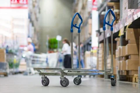 Rows of shelves with boxes and storage carts in modern warehouse Foto stock