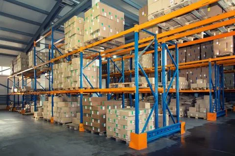 Rows of shelves with boxes in big modern warehouse Stock Photos