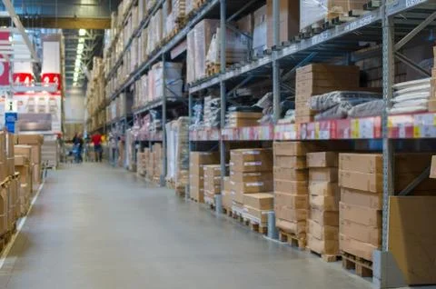 Rows of shelves with boxes in modern warehouse Stock Photos
