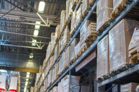 Rows of shelves with boxes in modern warehouse Stock Photos