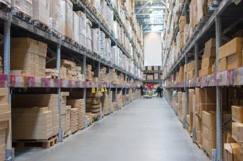 Rows of shelves with boxes in modern warehouse Stock Photos