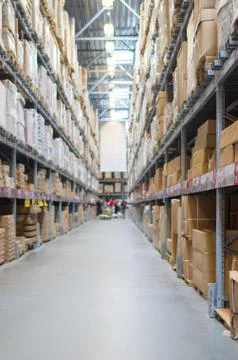 Rows of shelves with boxes in modern warehouse Stock Photos