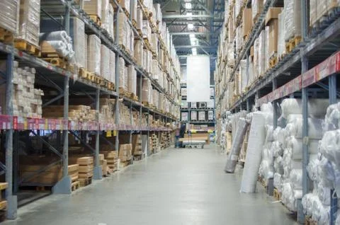 Rows of shelves with boxes in modern warehouse Stock Photos
