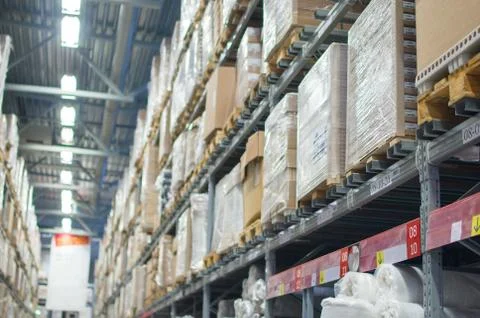 Rows of shelves with boxes in modern warehouse Stock Photos