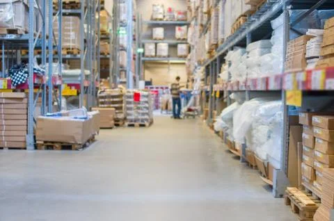 Rows of shelves with boxes in modern warehouse Stock Photos