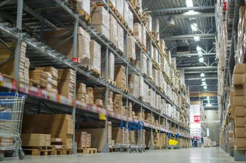 Rows of shelves with boxes in modern warehouse Stock Photos
