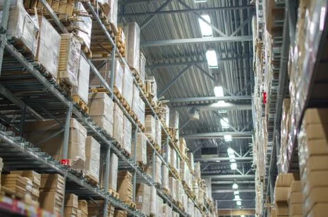 Rows of shelves with boxes in modern warehouse Stock Photos