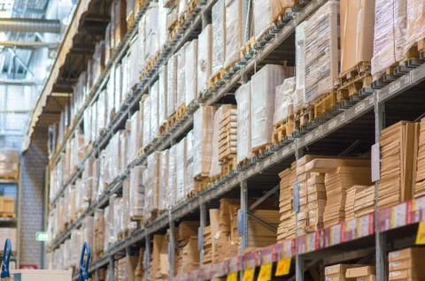 Rows of shelves with boxes in modern warehouse Stock Photos