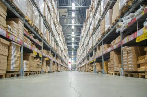 Rows of shelves with boxes in modern warehouse Stock Photos