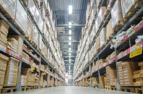 Rows of shelves with boxes in modern warehouse Stock Photos