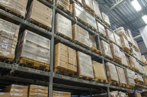 Rows of shelves with boxes in modern warehouse Foto stock