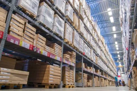 Rows of shelves with boxes in modern warehouse Stock Photos
