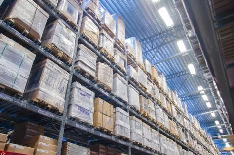 Rows of shelves with boxes in modern warehouse Stock Photos