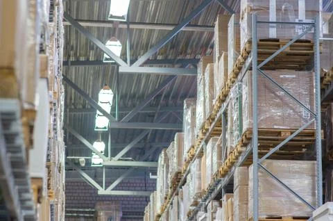 Rows of shelves with boxes in modern warehouse Stock Photos