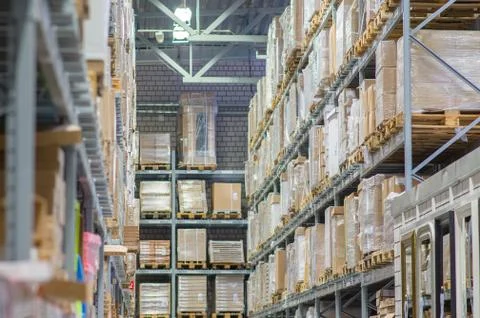 Rows of shelves with boxes in modern warehouse Stock Photos